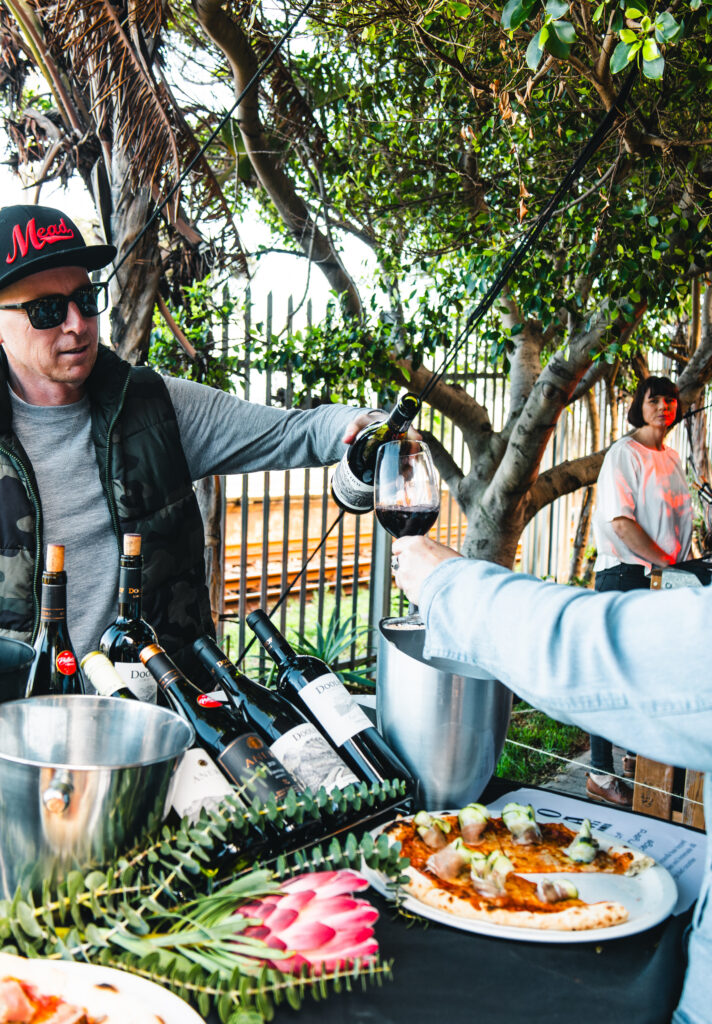 Vino Pizza Fest 2026 Wine being poured beside pizza in Folk Café’s garden